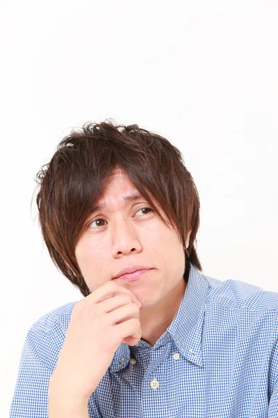 　young Japanese man worries about something